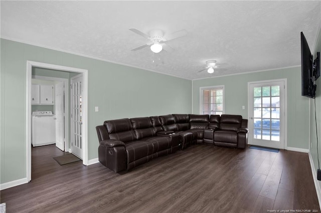 living room featuring washer / dryer, dark hardwood / wood-style floors, a textured ceiling, ceiling fan, and ornamental molding