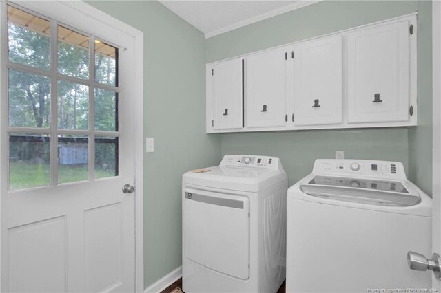 washroom featuring independent washer and dryer, cabinets, and plenty of natural light