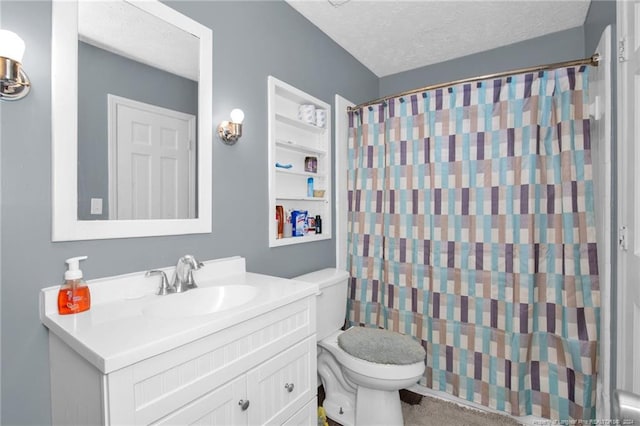 bathroom featuring toilet, vanity, and a textured ceiling