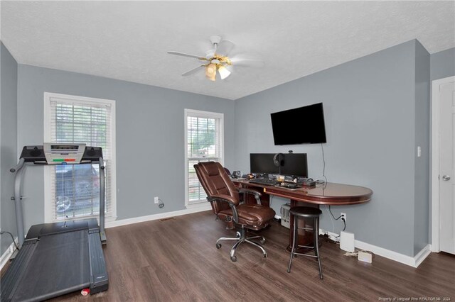 office area featuring plenty of natural light, dark wood-type flooring, and ceiling fan