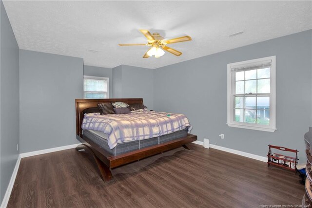 bedroom featuring dark hardwood / wood-style flooring and ceiling fan