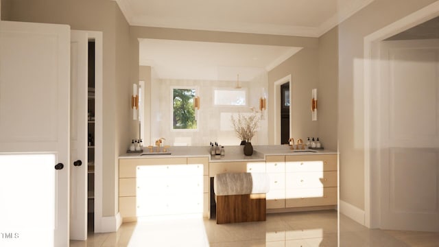 bathroom featuring tile patterned flooring, crown molding, and a sink