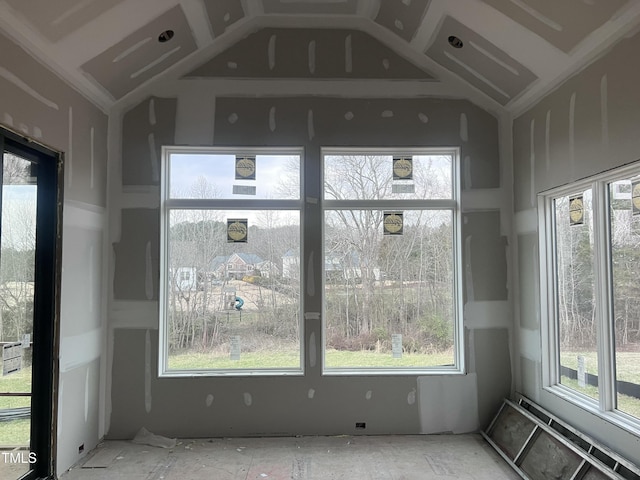 unfurnished sunroom featuring lofted ceiling and plenty of natural light