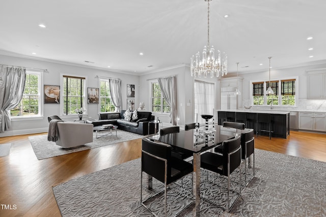 dining area featuring recessed lighting, plenty of natural light, light wood finished floors, and ornamental molding