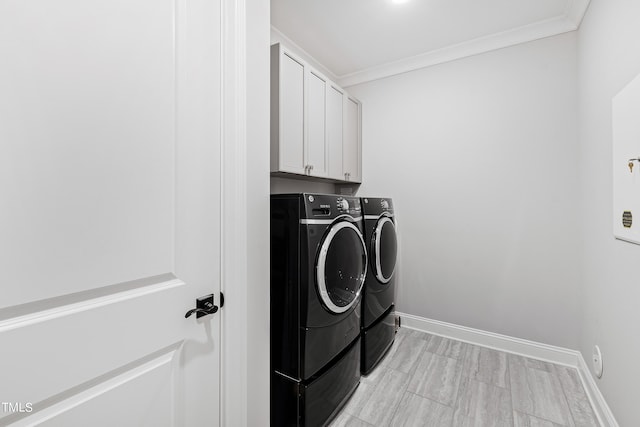 laundry room featuring baseboards, independent washer and dryer, cabinet space, and crown molding