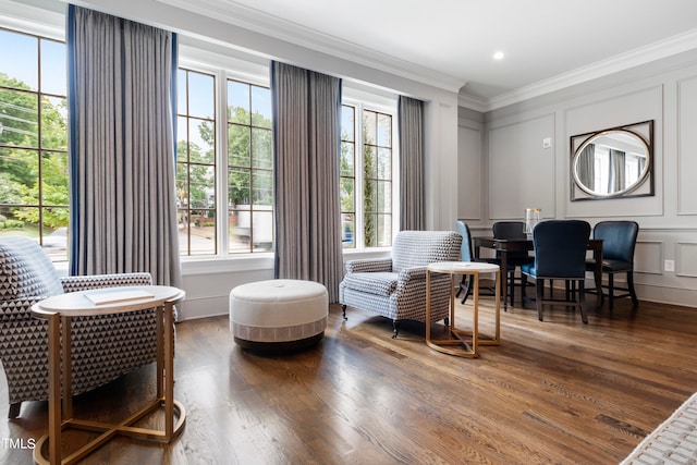 living area with crown molding and dark hardwood / wood-style flooring