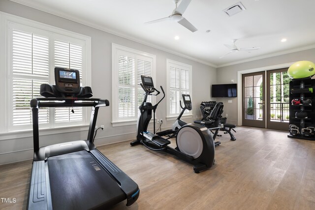 gym featuring crown molding, light hardwood / wood-style flooring, and ceiling fan