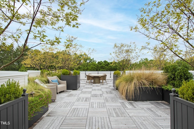 view of patio featuring a wooden deck and outdoor dining area