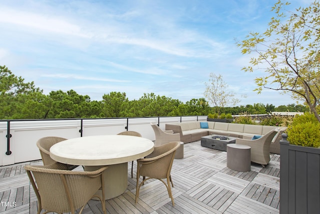 deck featuring an outdoor living space with a fire pit and outdoor dining area