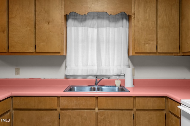 kitchen with white stove and sink