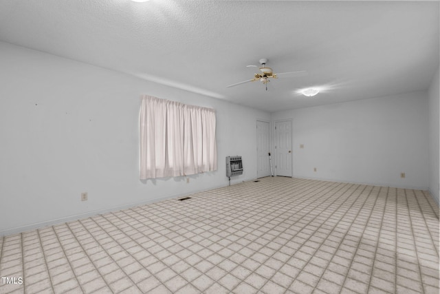 empty room with heating unit and ceiling fan