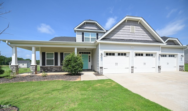 craftsman-style house featuring a garage, a porch, and a front yard