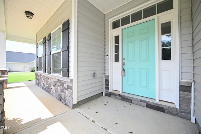 view of exterior entry with covered porch