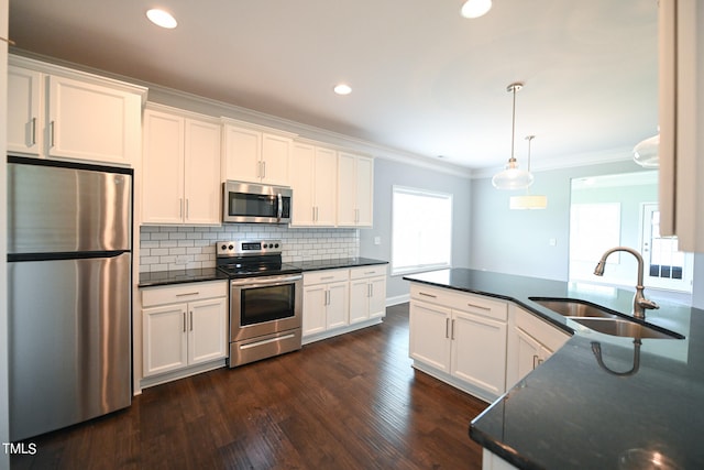 kitchen with sink, appliances with stainless steel finishes, dark hardwood / wood-style flooring, and white cabinetry