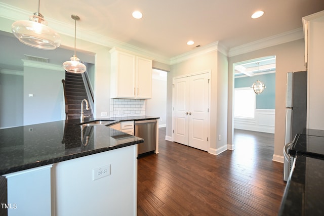 kitchen featuring dark hardwood / wood-style floors, stainless steel appliances, sink, and ornamental molding