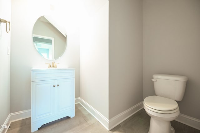 bathroom with vanity, tile patterned flooring, and toilet