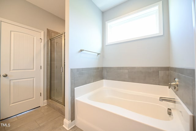 bathroom with tile patterned flooring and independent shower and bath