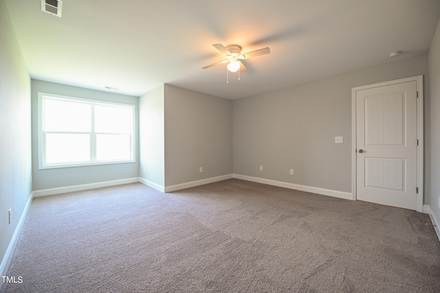 spare room featuring carpet floors and ceiling fan