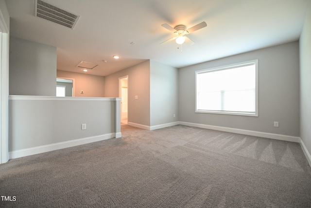 carpeted spare room featuring ceiling fan