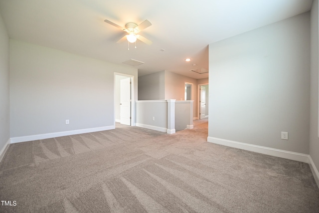 unfurnished room featuring light carpet and ceiling fan