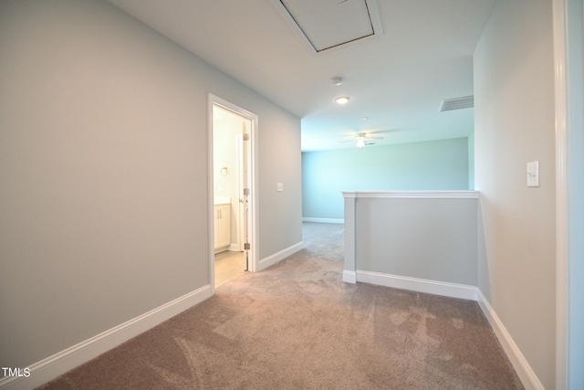 carpeted spare room featuring ceiling fan