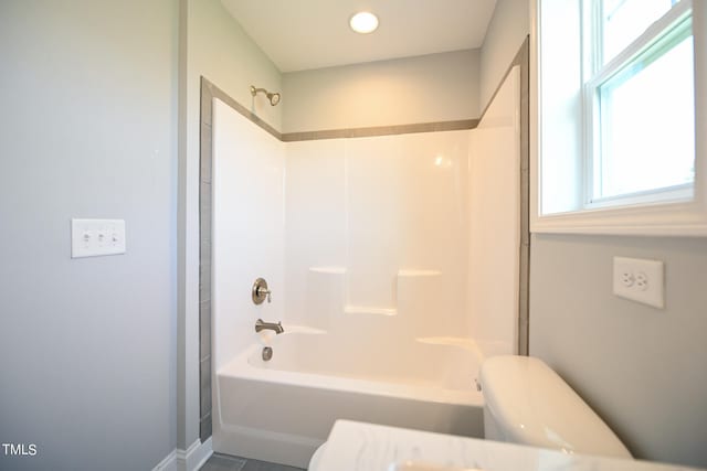 bathroom with shower / bath combination and toilet