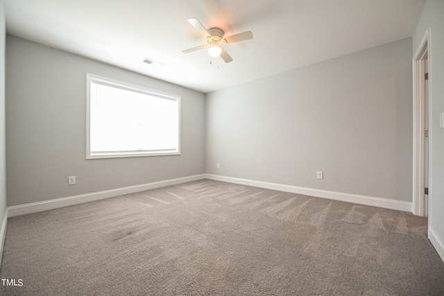 carpeted empty room featuring ceiling fan