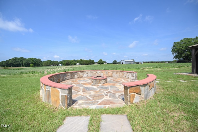 surrounding community featuring a yard and a fire pit