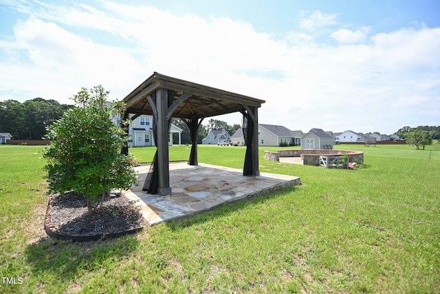 view of yard with a patio, a storage unit, and a gazebo