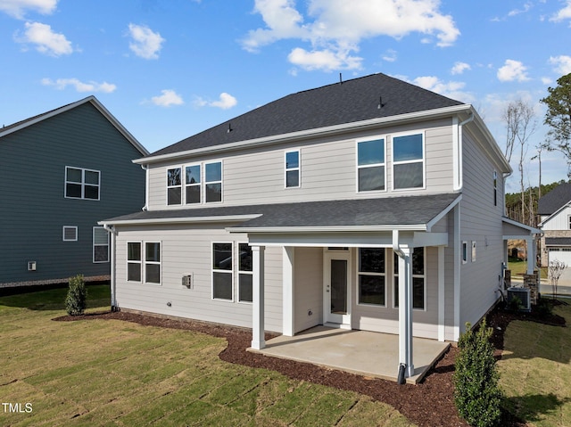 back of property featuring a yard, central AC, and a patio area