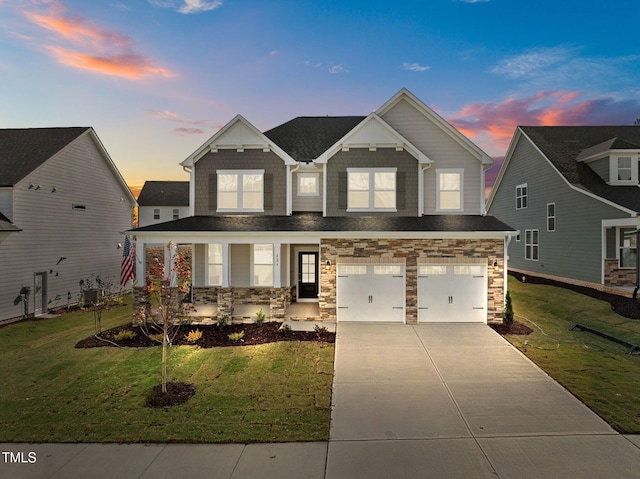 view of front of house with a yard, a garage, and cooling unit