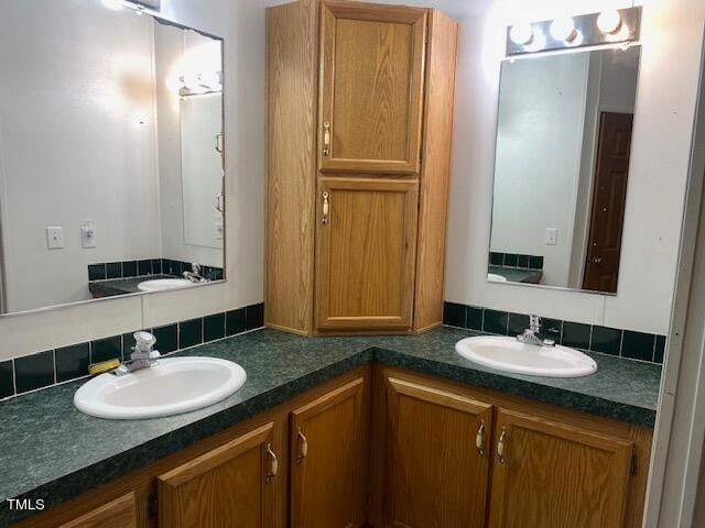 bathroom featuring vanity and tasteful backsplash