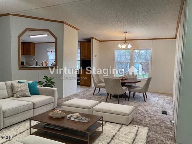 carpeted living room featuring ornamental molding, a textured ceiling, sink, and a notable chandelier