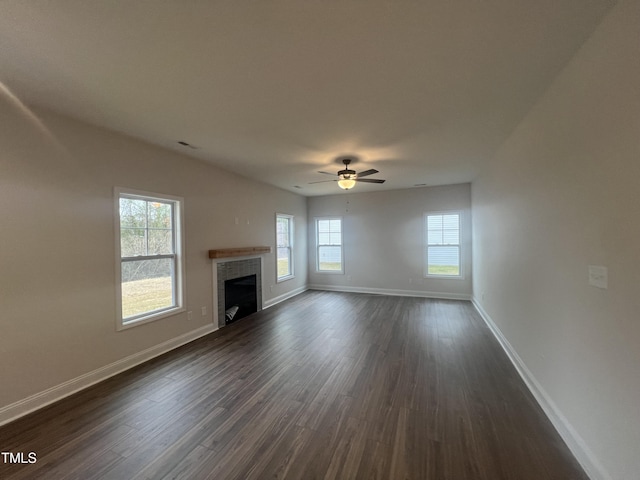 unfurnished living room featuring ceiling fan and dark hardwood / wood-style floors