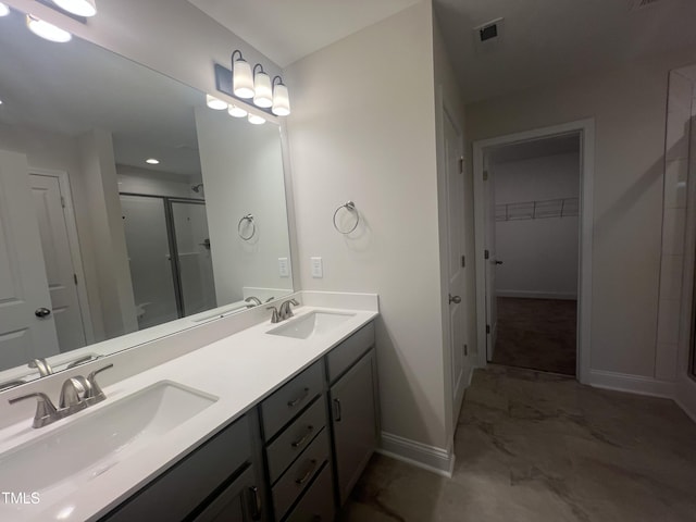 bathroom featuring an enclosed shower and vanity