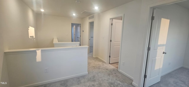 corridor featuring baseboards, visible vents, and carpet flooring