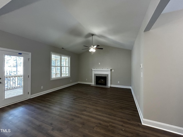 unfurnished living room featuring dark wood-style floors, lofted ceiling, and a fireplace