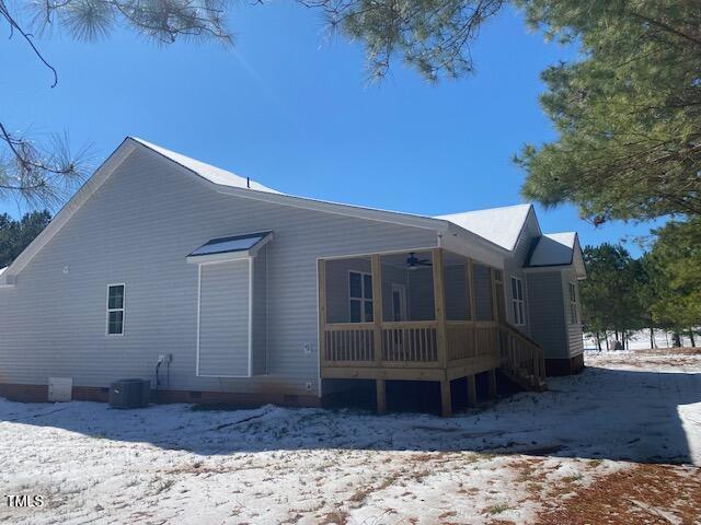 view of snow covered exterior with crawl space, central AC, and ceiling fan