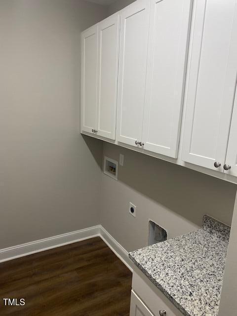 laundry area with washer hookup, cabinet space, dark wood-type flooring, hookup for an electric dryer, and baseboards