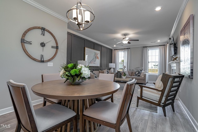 dining room featuring baseboards, crown molding, and wood finished floors