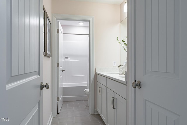 bathroom featuring tile patterned flooring, vanity, toilet, and bathing tub / shower combination