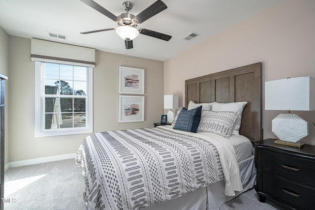 bedroom featuring a ceiling fan, visible vents, light carpet, and baseboards