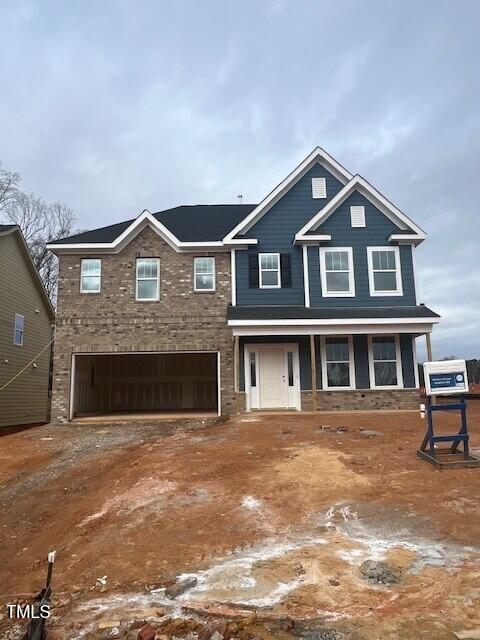 view of front of property featuring a garage and covered porch