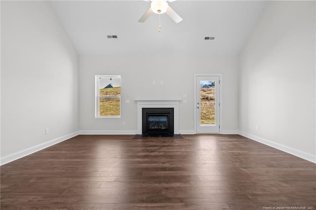 unfurnished living room featuring ceiling fan and dark wood-type flooring