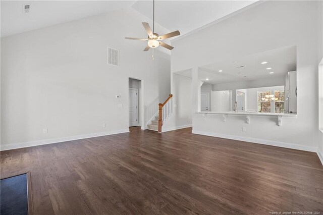 unfurnished living room featuring high vaulted ceiling, ceiling fan, dark wood-type flooring, and sink