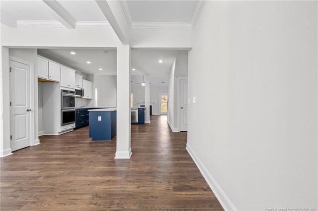 kitchen featuring a kitchen breakfast bar, dark hardwood / wood-style flooring, a center island, and white cabinetry