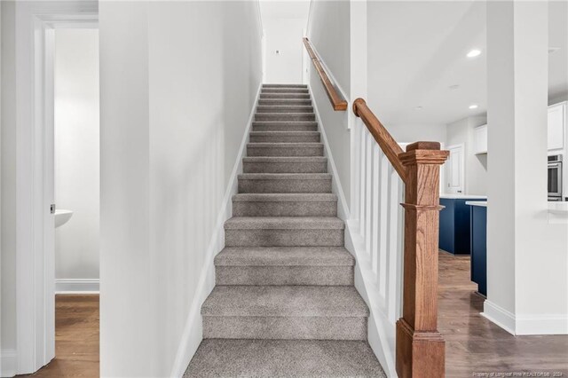 staircase featuring hardwood / wood-style floors