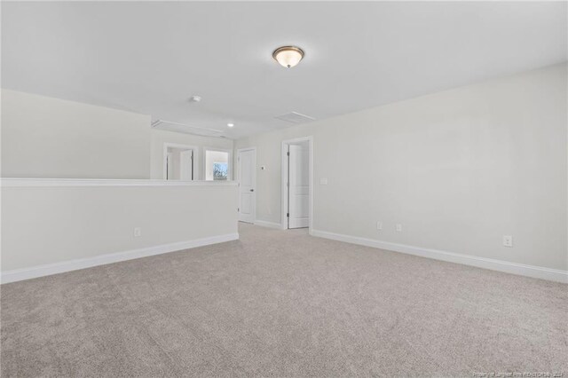 spare room featuring light colored carpet