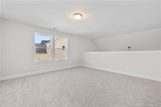 bonus room with carpet floors and vaulted ceiling