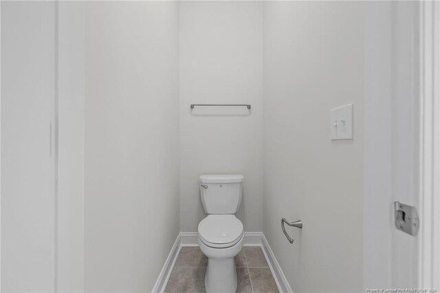 bathroom with tile patterned flooring and toilet